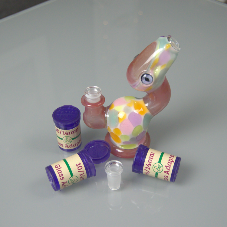 3 containers containing 10/14mm glass adapters infront of a 14mm piece that has a 10mm adapter in it