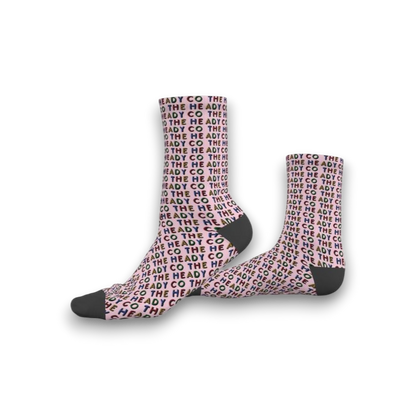 Pink socks with 'The Heady Co' pattern