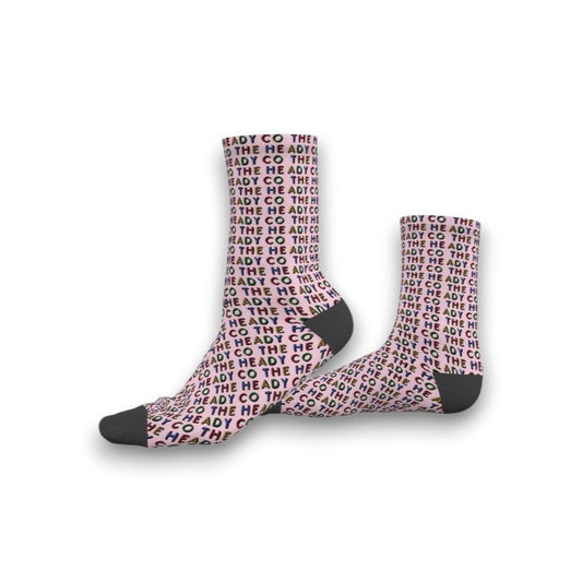Pink socks with 'The Heady Co' pattern