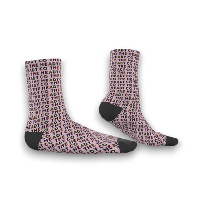 Pink socks with 'he Heady Co.' pattern