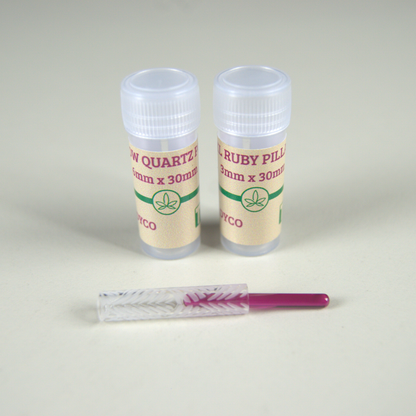 A Hollow Quartz Pillar and a 6x30mm Ruby Pillar, both made by THCo., in front of their packaging