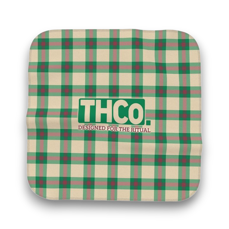 Green and beige plaid microfibre cloth with 'THCO.' logo 